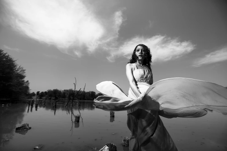 a woman standing on top of a body of water