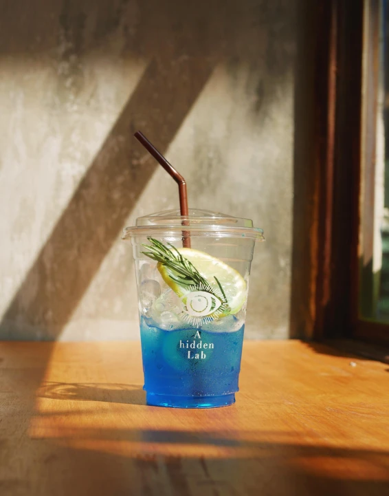 a cup sitting on a table with a straw inside of it