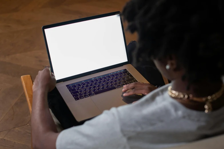 a woman working on her laptop with a large white screen