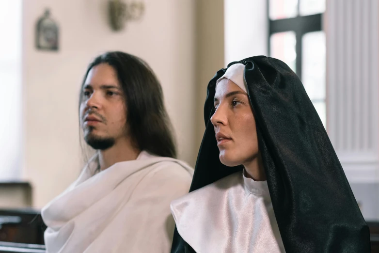 a man and woman in nun costumes with long hair