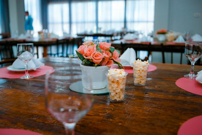 table set for a party with vases filled with flowers and candles