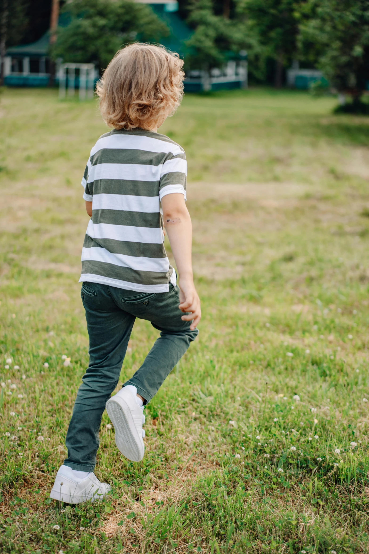 a child in the grass playing with a frisbee