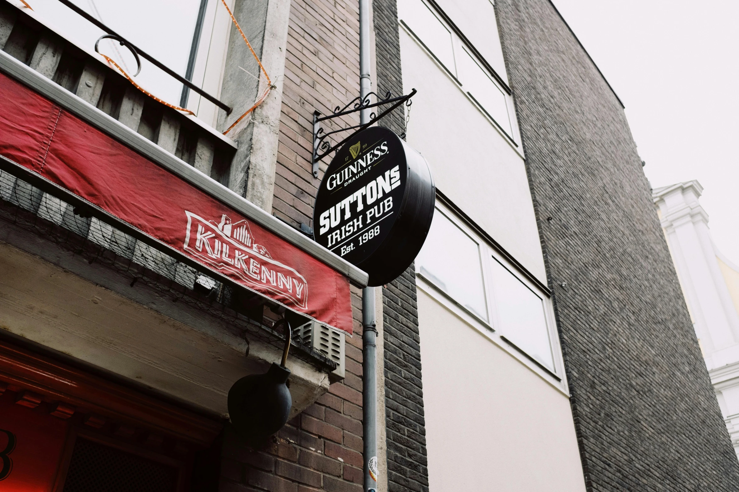 a sign hanging from a wall outside a building