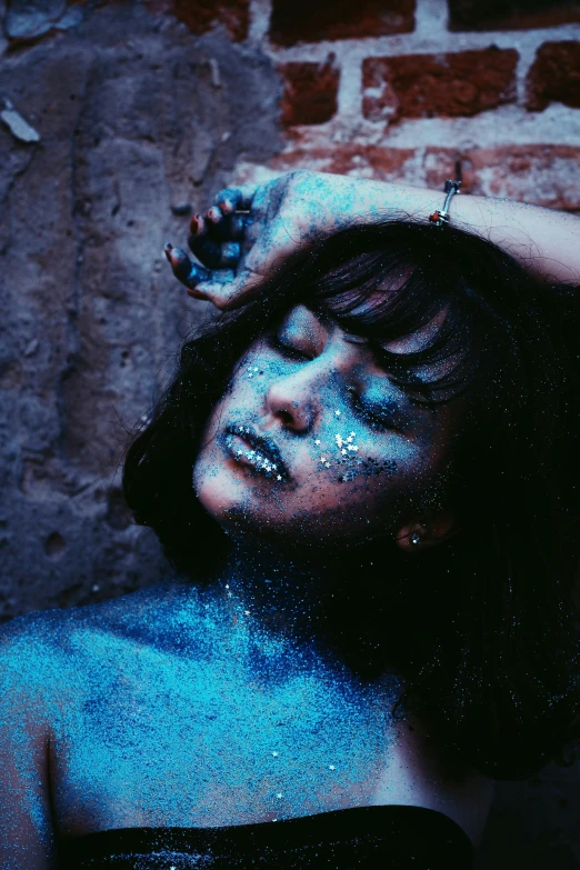 a woman has blue powder on her face