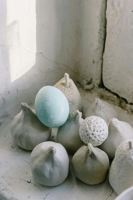 a white vase holding a light blue object