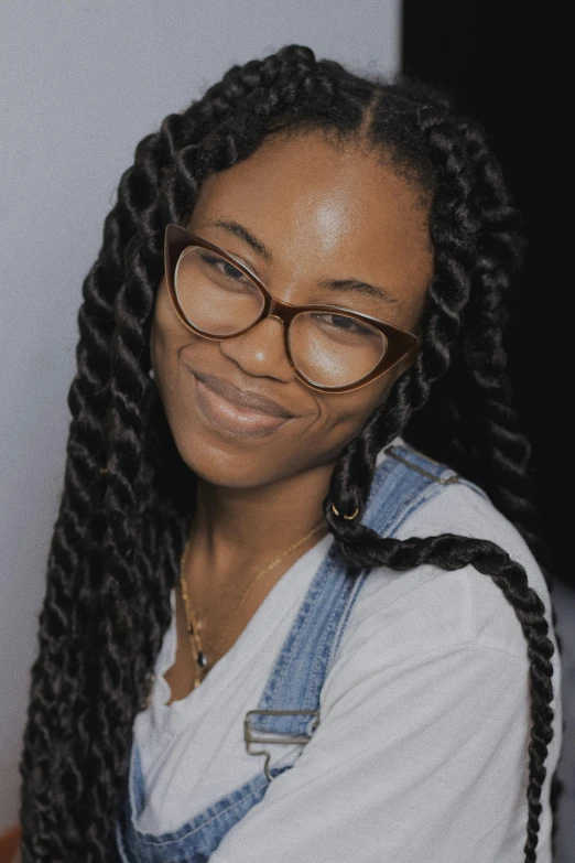 a young black woman with ids and glasses