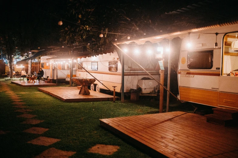 an outdoor covered in lights and wooden benches