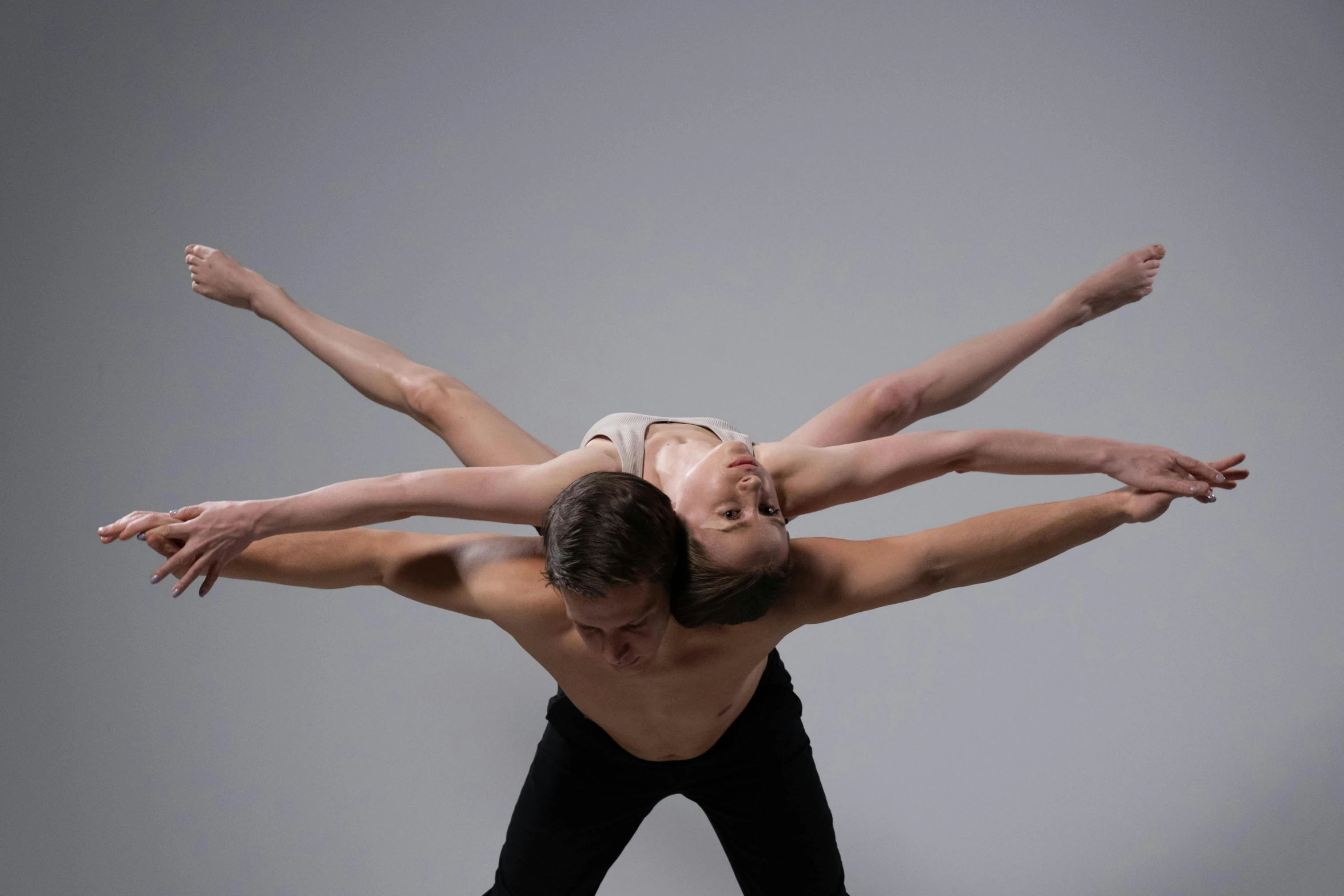 two young men performing on a gray background