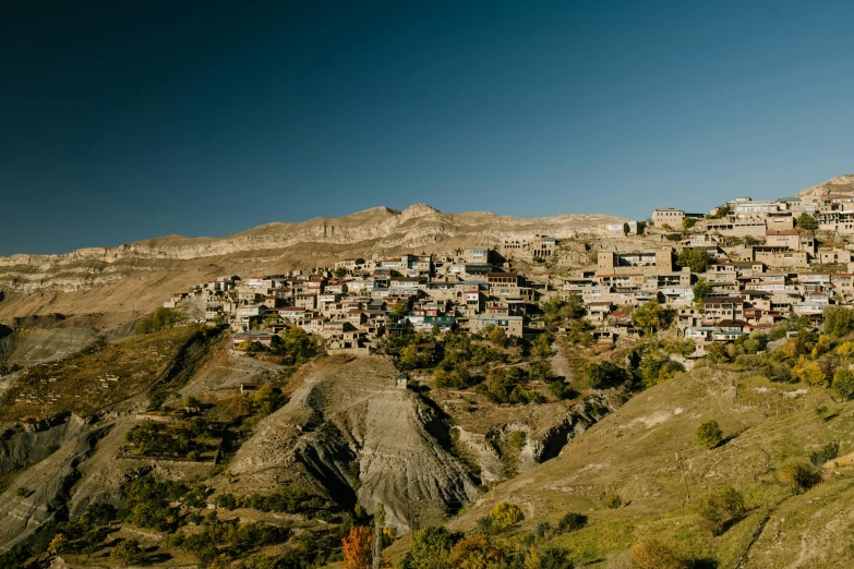 a mountain side village with a hillside covered in buildings