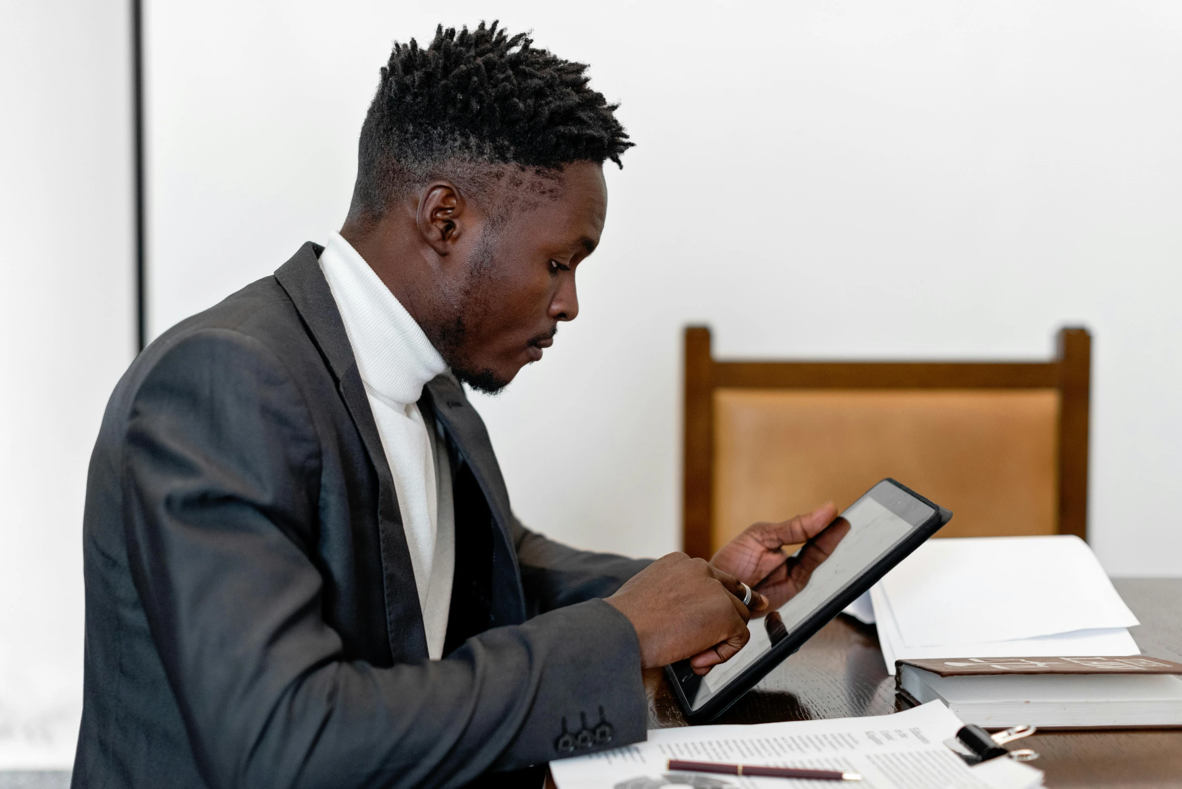 a person sits at a table with a tablet