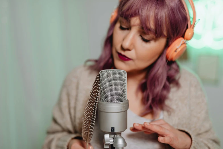 a lady wearing headphones with a microphone in her hand