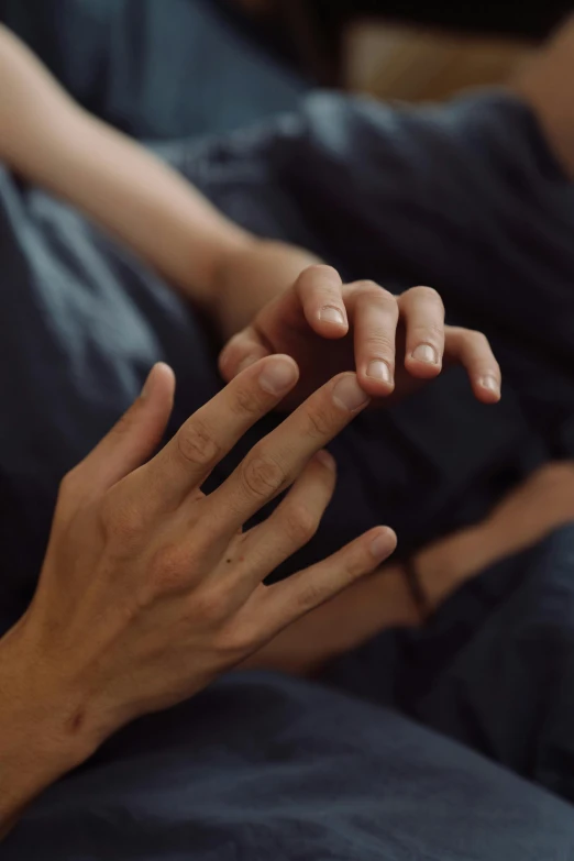 a hand with two fingers extended over another hand