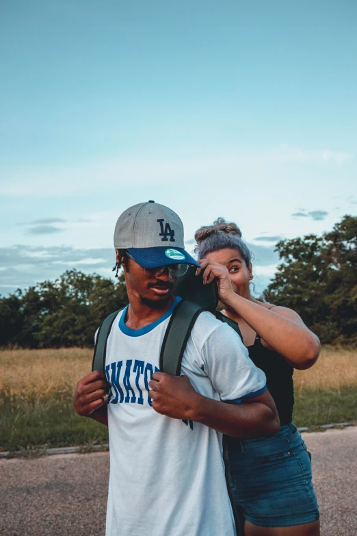 a man is holding a woman who is covering her eyes