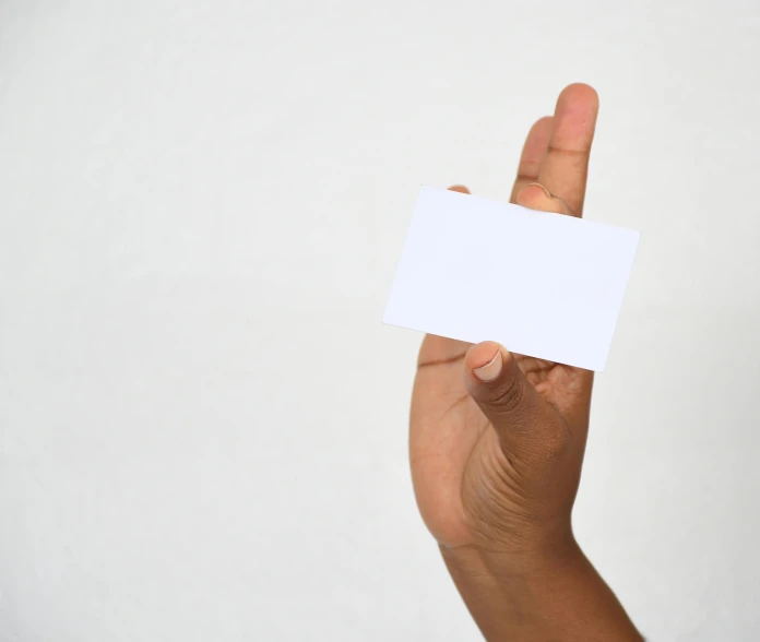 the man holds up his blank card in the palm