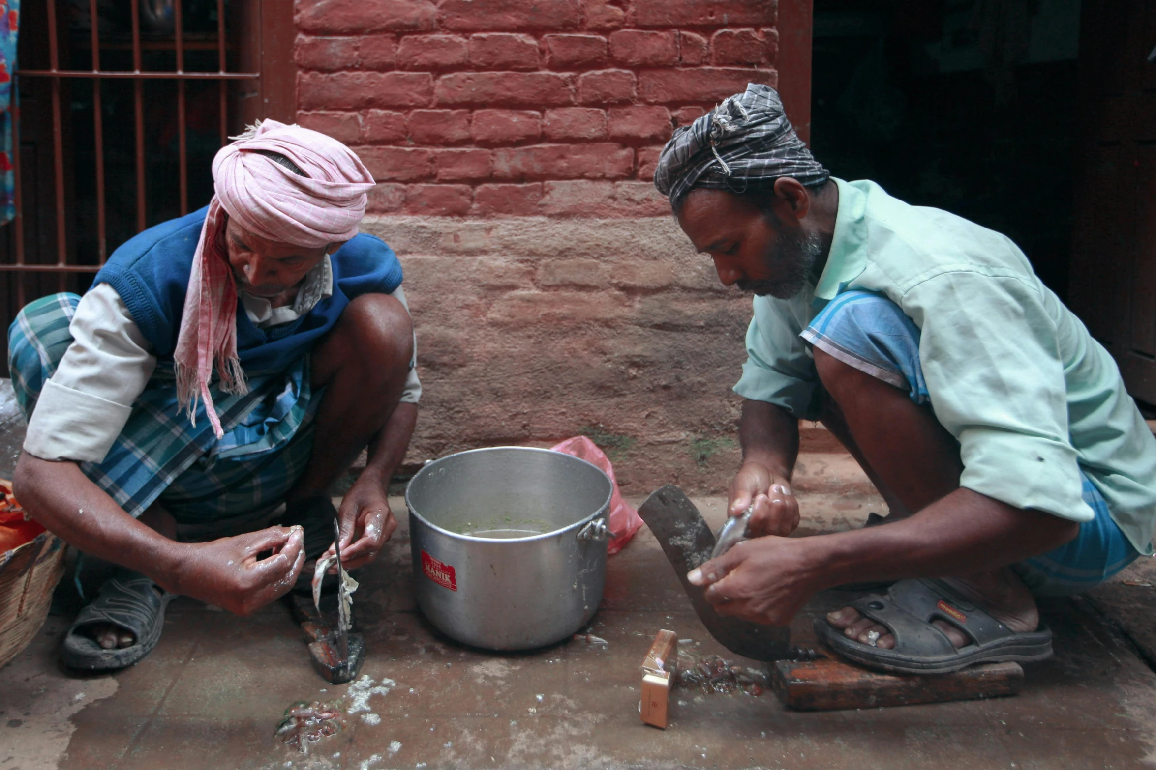 two people are cooking together with a big pot