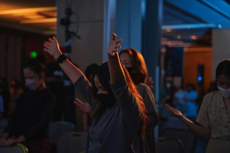 an audience of people standing and clapping at a party