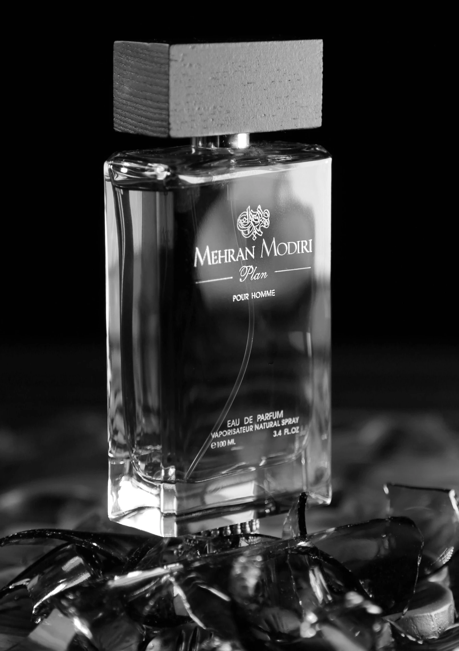 a bottle of perfume with black and white po in background