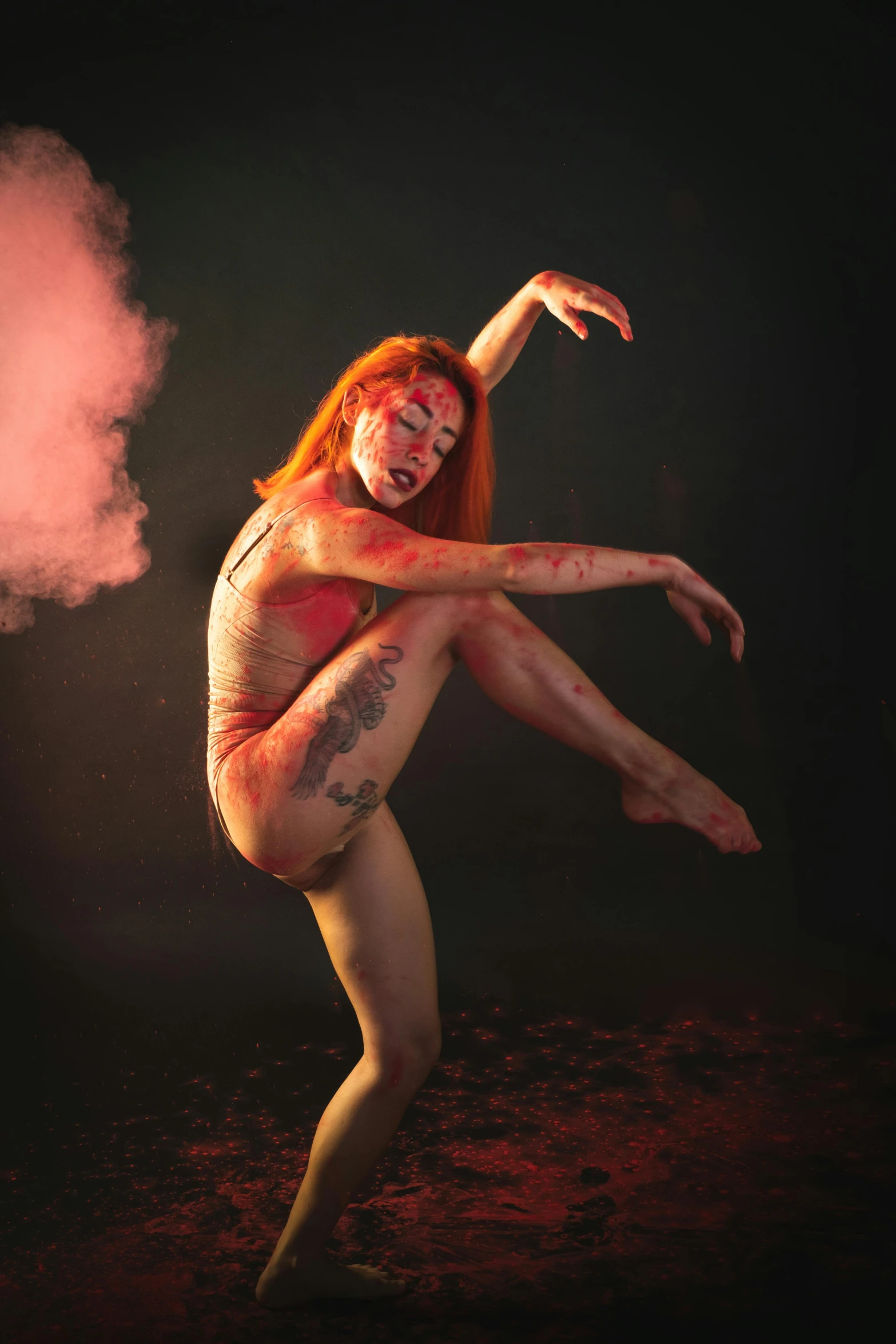 a woman covered in red makeup and body paint