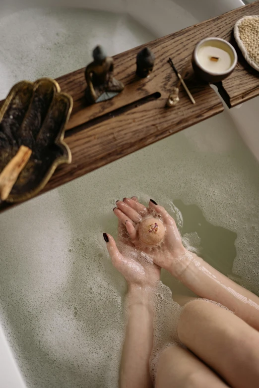 the woman is having her hands in a bathtub