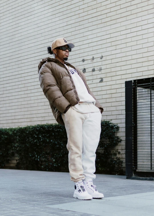 a man standing on the side walk next to a building