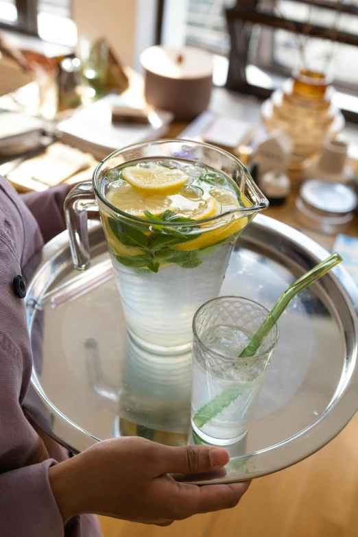 two glasses and a tray on a table with food