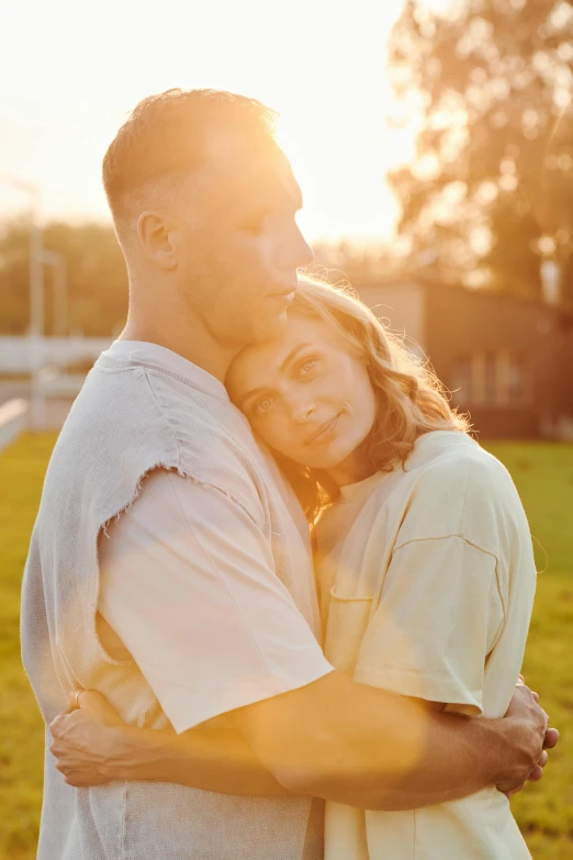 a man and woman are emcing on grass