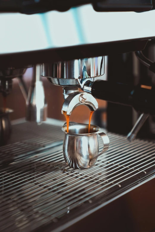 an espresso machine is pouring some coffee