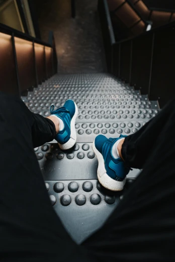 a close - up of someone's feet as they walk down a metal platform