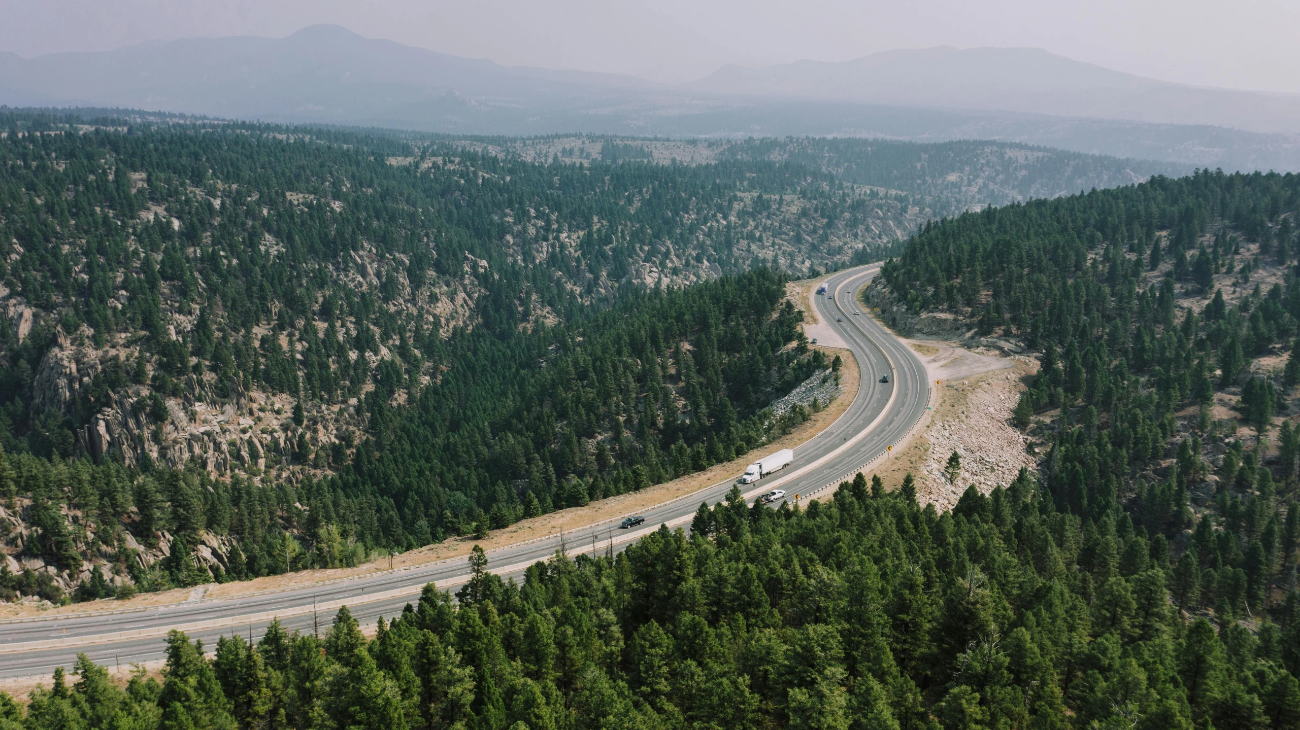 a road is shown in the distance in the wilderness