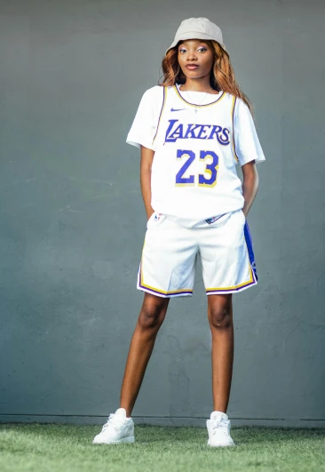 a woman posing for a picture wearing a basketball uniform