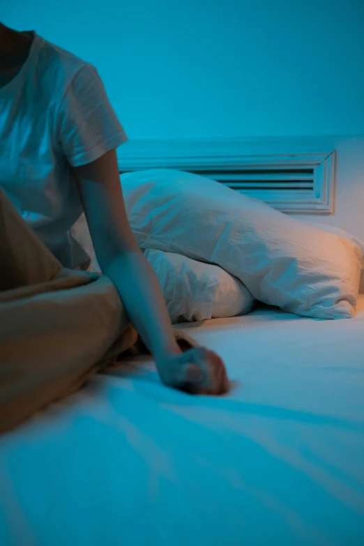 woman with arm in the air, next to bed