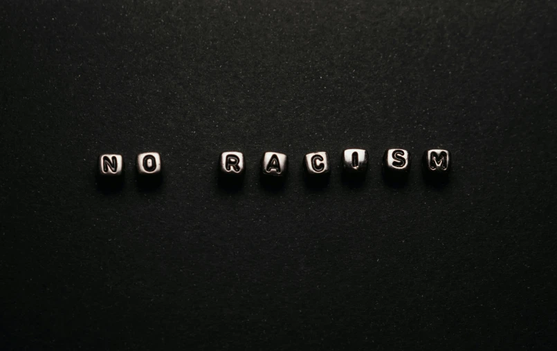 small letter cubes are laying in the same row on top of black surface