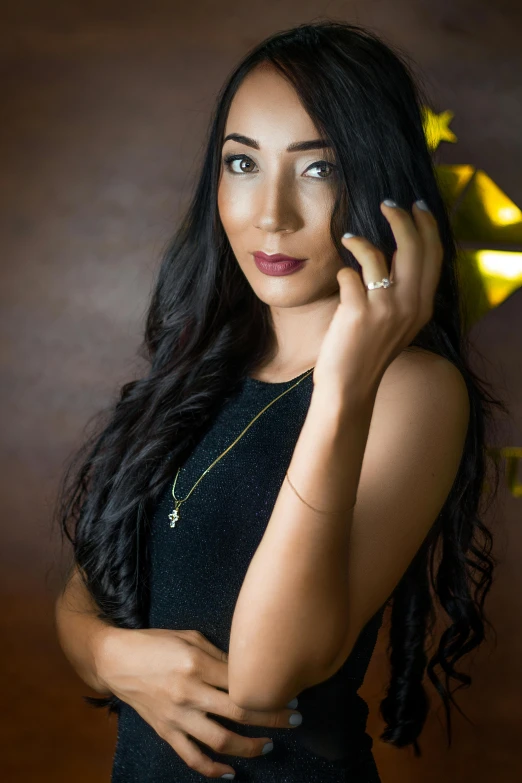 a beautiful young woman holding a gold ring