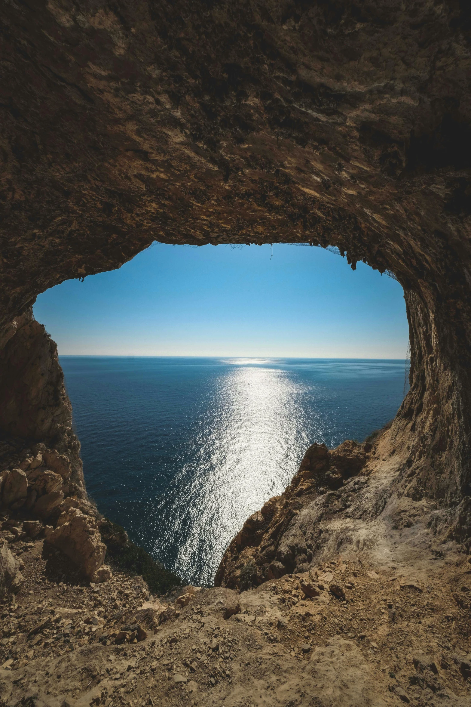 a large body of water seen from the inside of an ocean cave