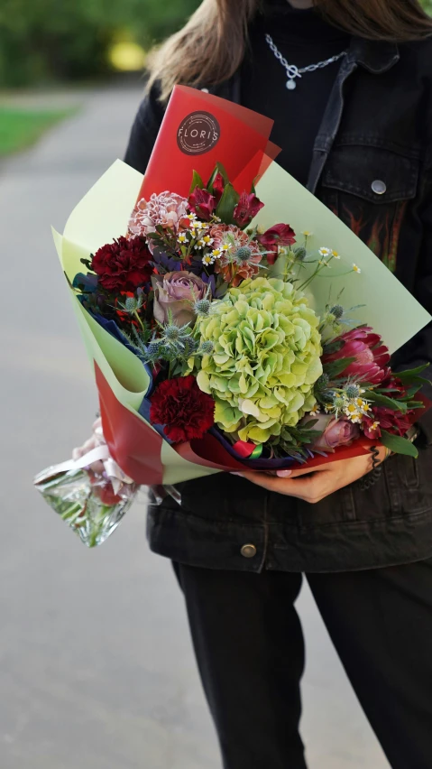 an individual is holding some kind of flower