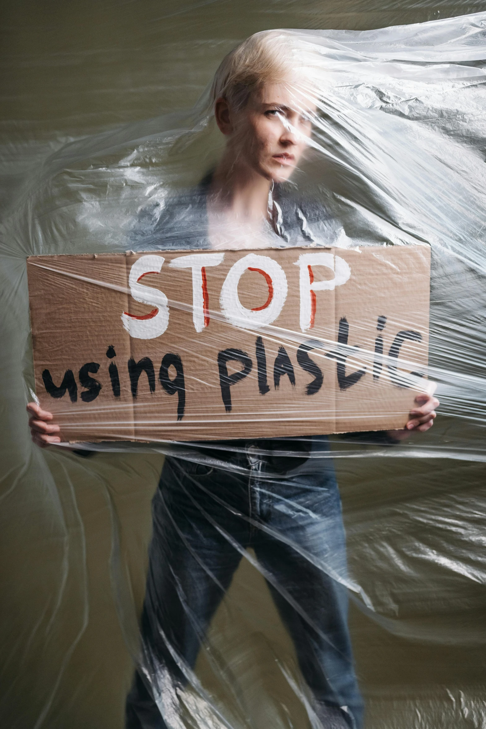 a man with a sign on his back and plastic wrap