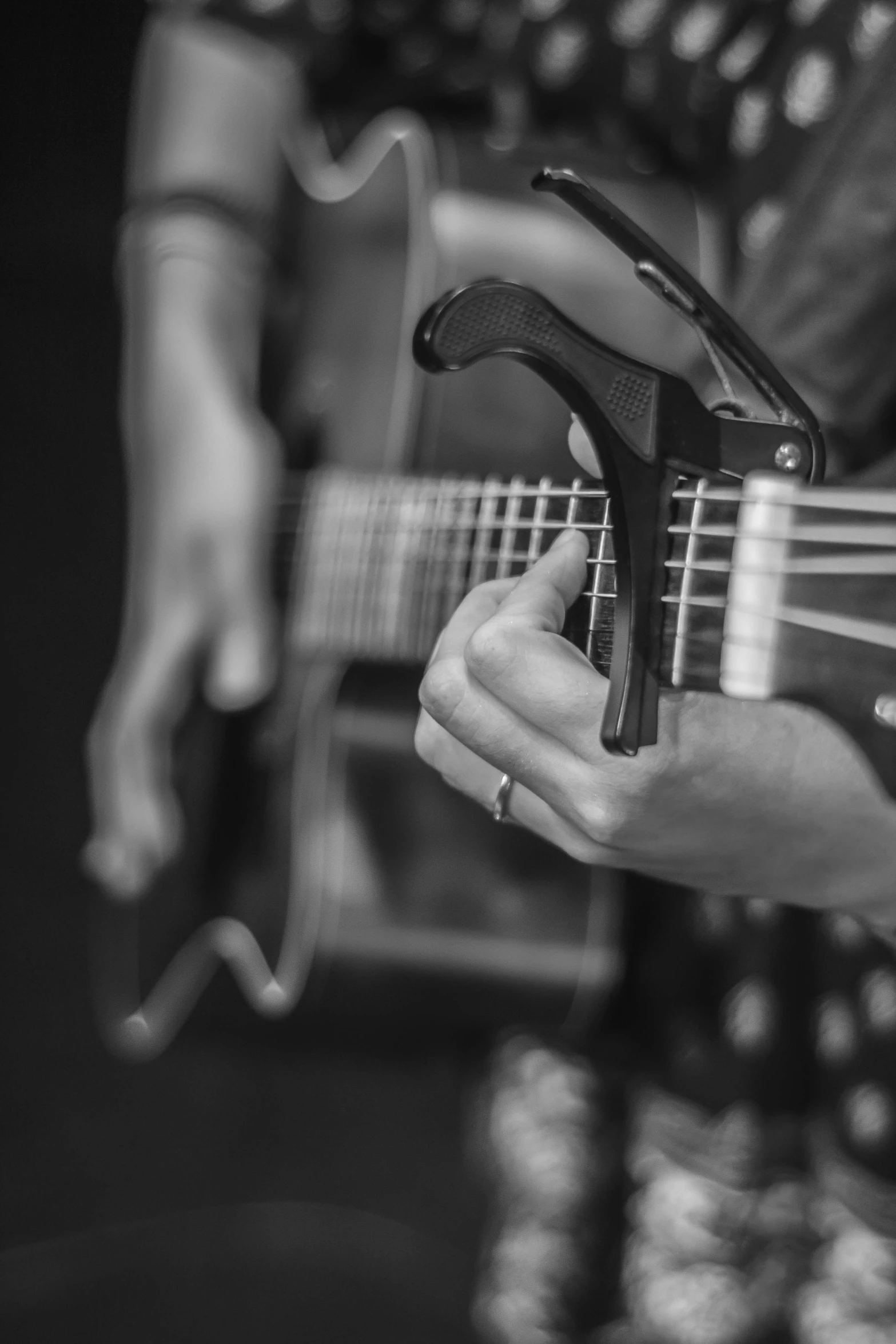 a woman with her guitar is holding a cord in one hand