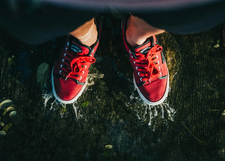 red tennis shoes with water running on them