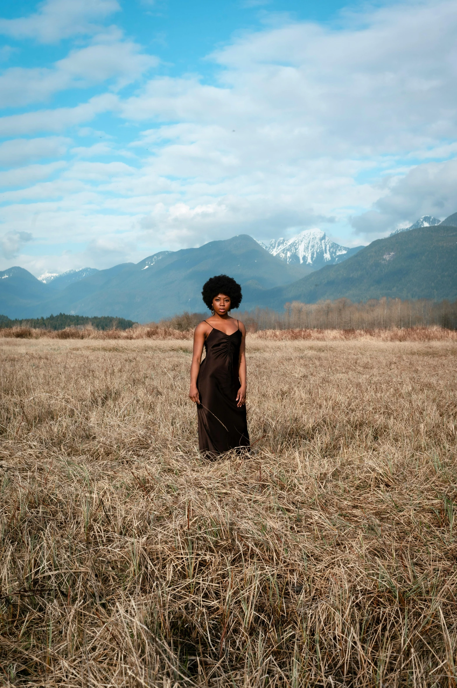 an african woman in an open field looking away