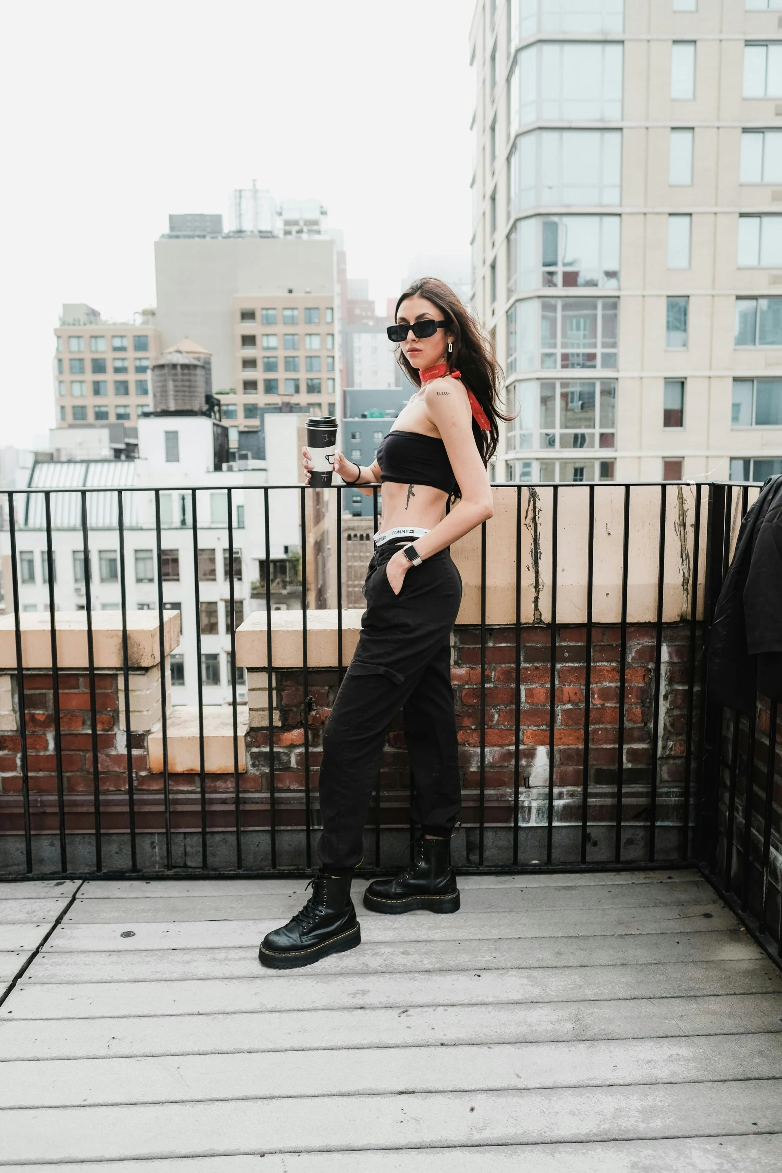 a woman in black clothes on the balcony