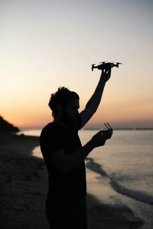 a person holding a small plane over their shoulder