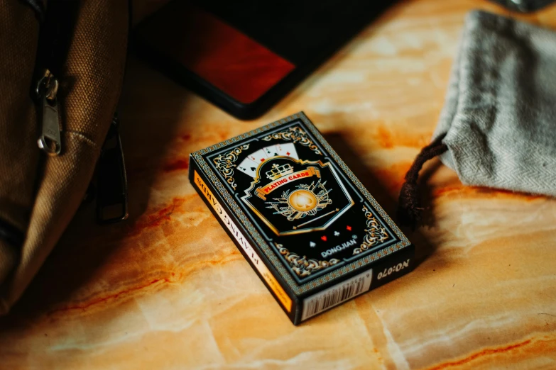 a colorful card case sits next to some books