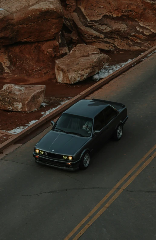 a car traveling down a road in the desert