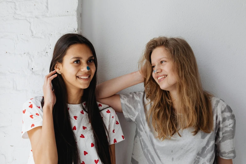 two girls with blue and red faces posing