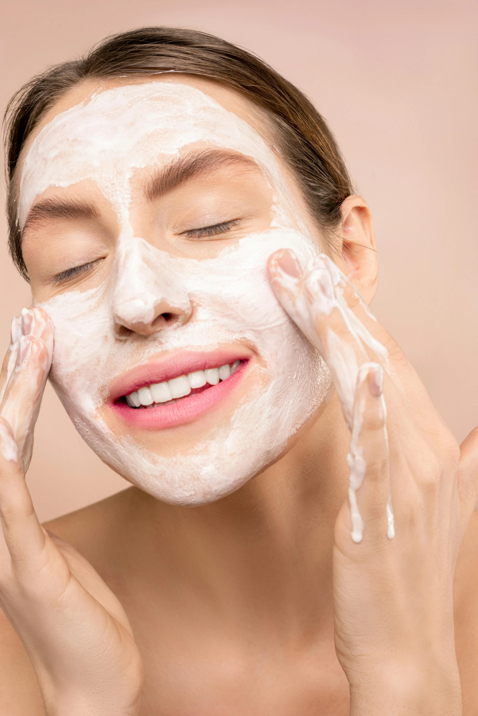 a woman is applying some clay on her face