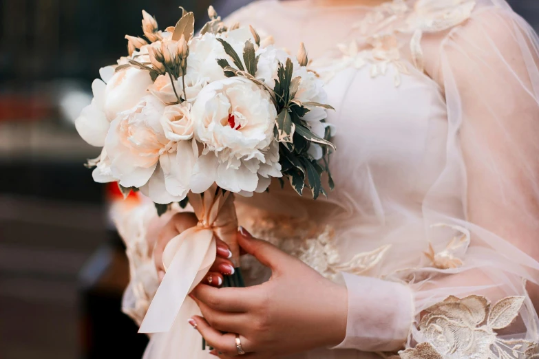 a close up of a bride holding her bouquet of flowers