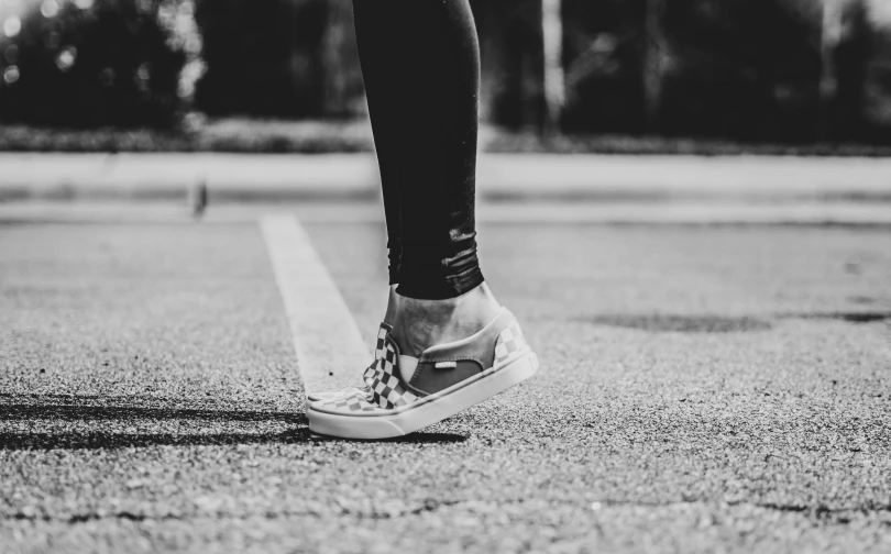 a person wearing black jeans and white sneakers