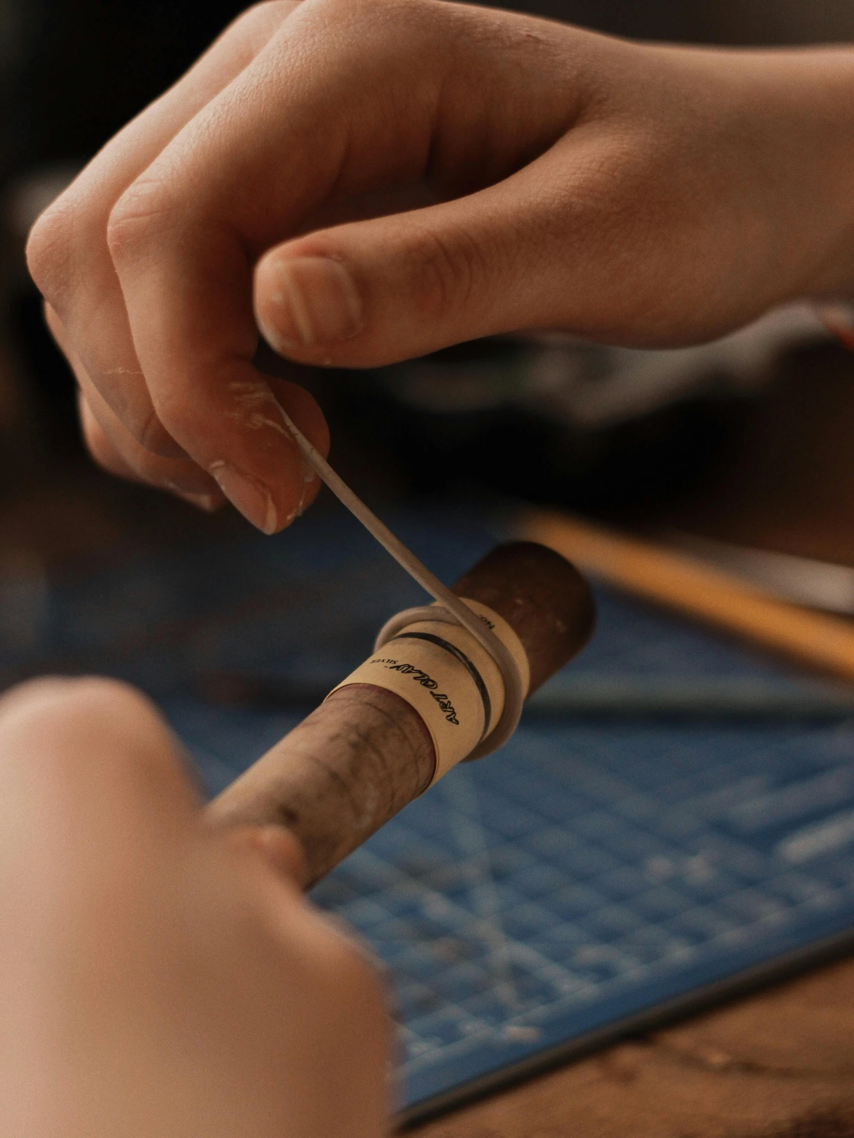 a person holding soing with a toothpick and needle in hand