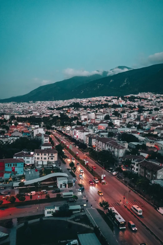 a city is shown with mountains in the background