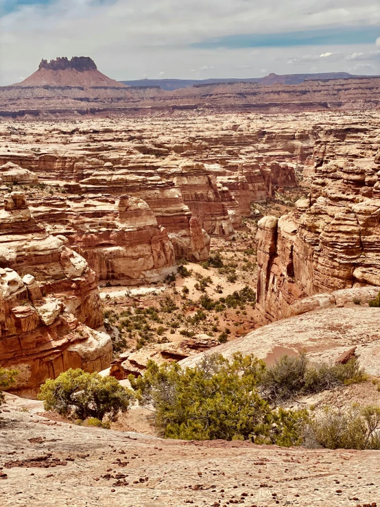 people sit in the dirt at the edge of a cliff